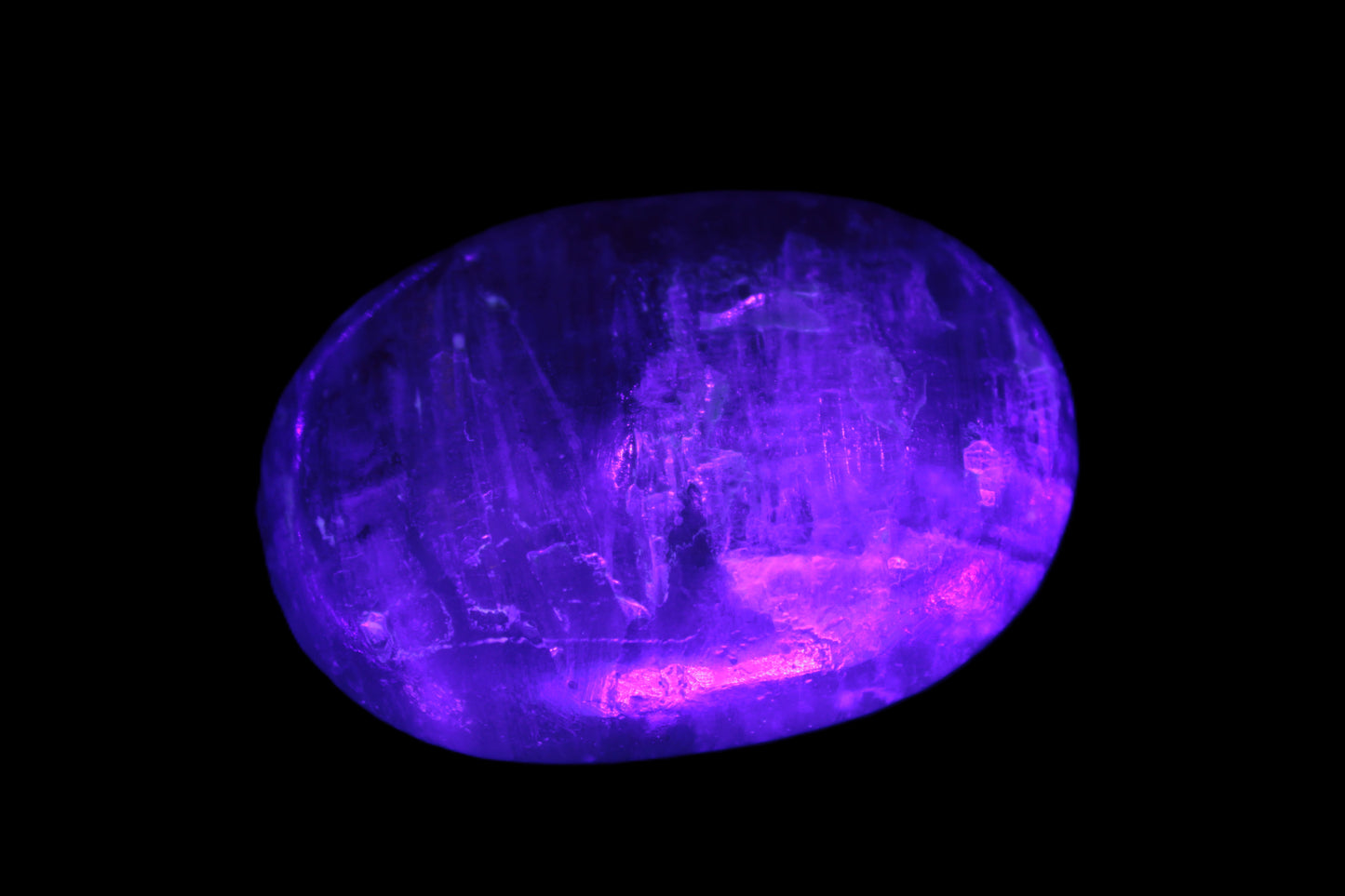 Pink Sorbet Calcite palm stone in UV light