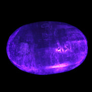 Pink Sorbet Calcite palm stone in UV light