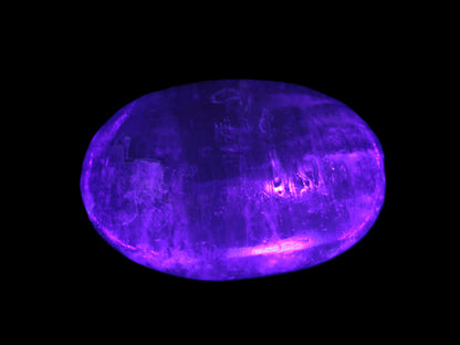 Pink Sorbet Calcite palm stone in UV light