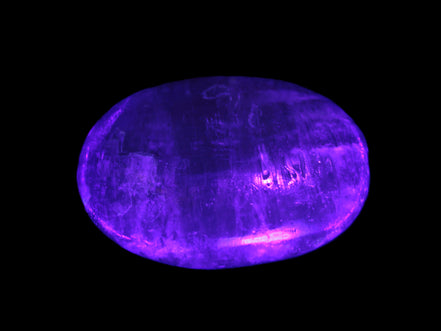 Pink Sorbet Calcite palm stone in UV light