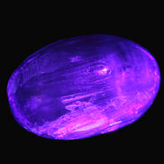 Pink Sorbet Calcite palm stone in UV light