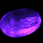 Pink Sorbet Calcite palm stone in UV light