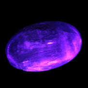 Pink Sorbet Calcite palm stone in UV light