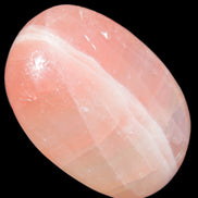 Pink Sorbet Calcite palm stone 57-61mm 71-117g in sunlight - Rocks and Things Store