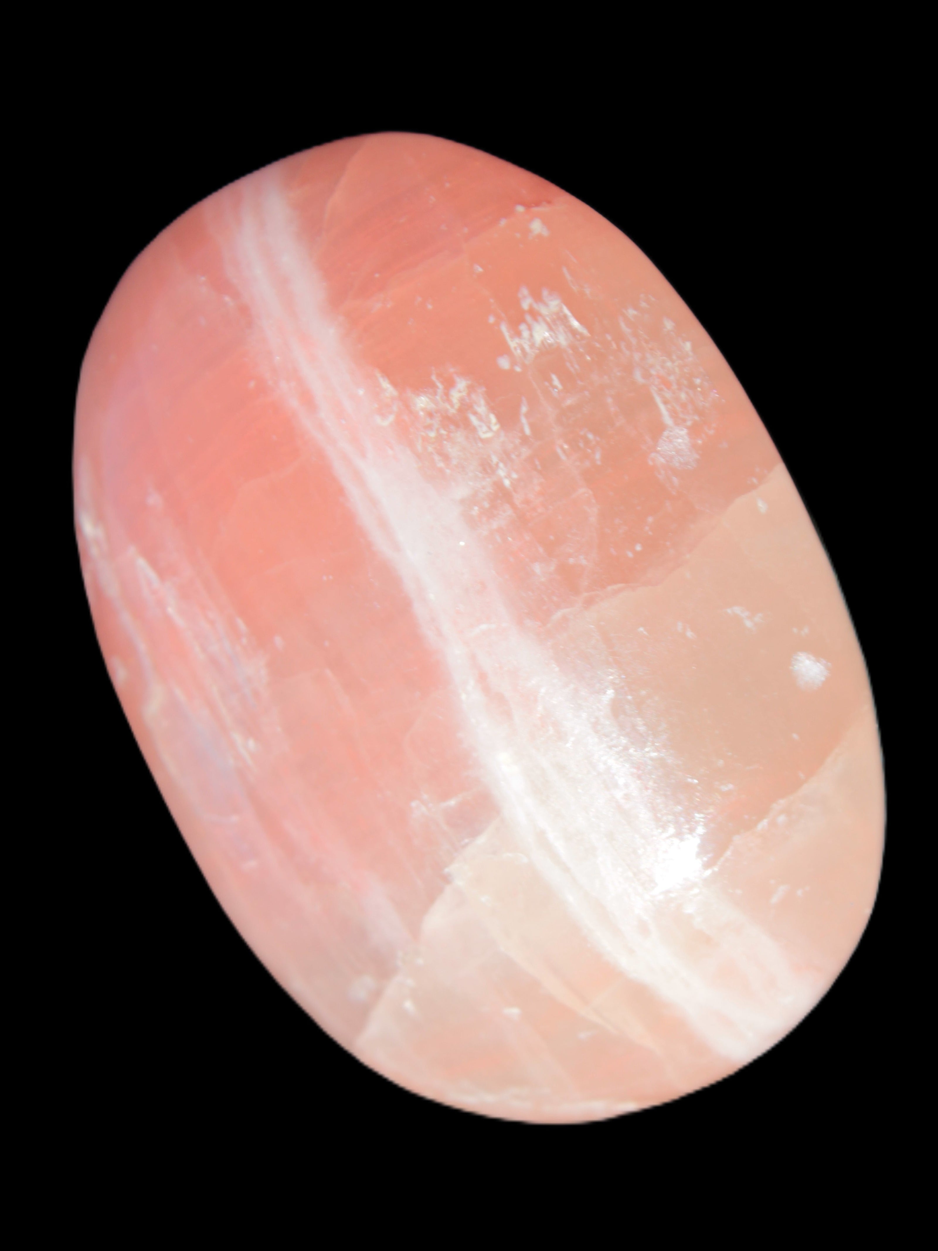 Pink Sorbet Calcite palm stone 57-61mm 71-117g in sunlight - Rocks and Things Store