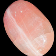 Pink Sorbet Calcite palm stone 57-61mm 71-117g in sunlight - Rocks and Things Store
