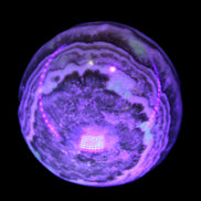 Beautiful Chocolate Calcite sphere 48mm 162g in UV light - Rocks and Things Store