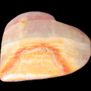 Calcite dyed hand-carved heart 61*58*16mm 85.5g in sunlight - Rocks and Things Store