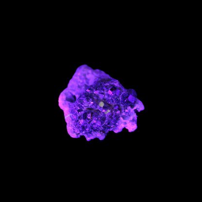 Tiny Spessartine Garnet cluster in UV light