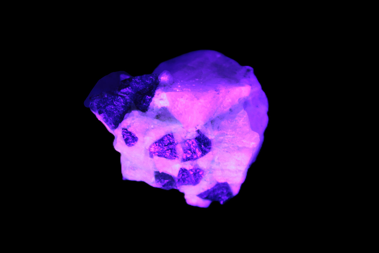 Black Elbaite cluster in matrix in UV light