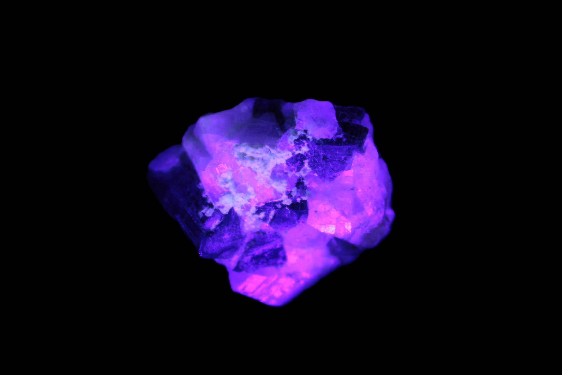 Black Elbaite cluster in matrix in UV light