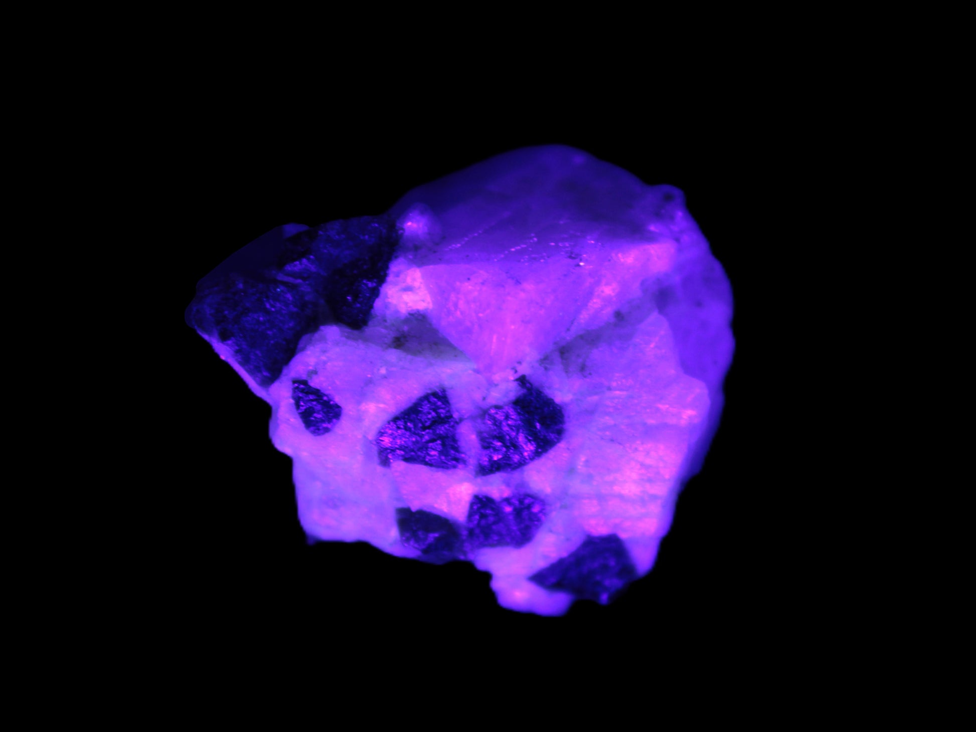 Black Elbaite cluster in matrix in UV light