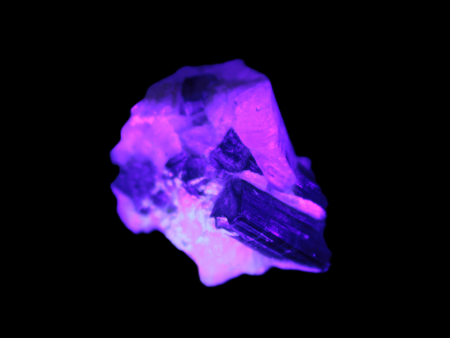 Black Elbaite cluster in matrix in UV light