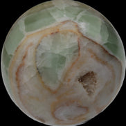 Orange, Lime & Lemon Aragonite sphere 648g in sunlight - Rocks and Things Store