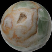 Orange, Lime & Lemon Aragonite sphere 648g in sunlight - Rocks and Things Store