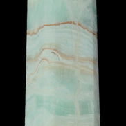 Pistachio Calcite obelisk 131*37*30mm 324g in sunlight - Rocks and Things Store