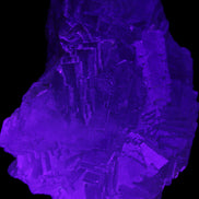 Clear Fluorite cubic stepped cluster 104*72*50mm 660g in UV light - Rocks and Things Store
