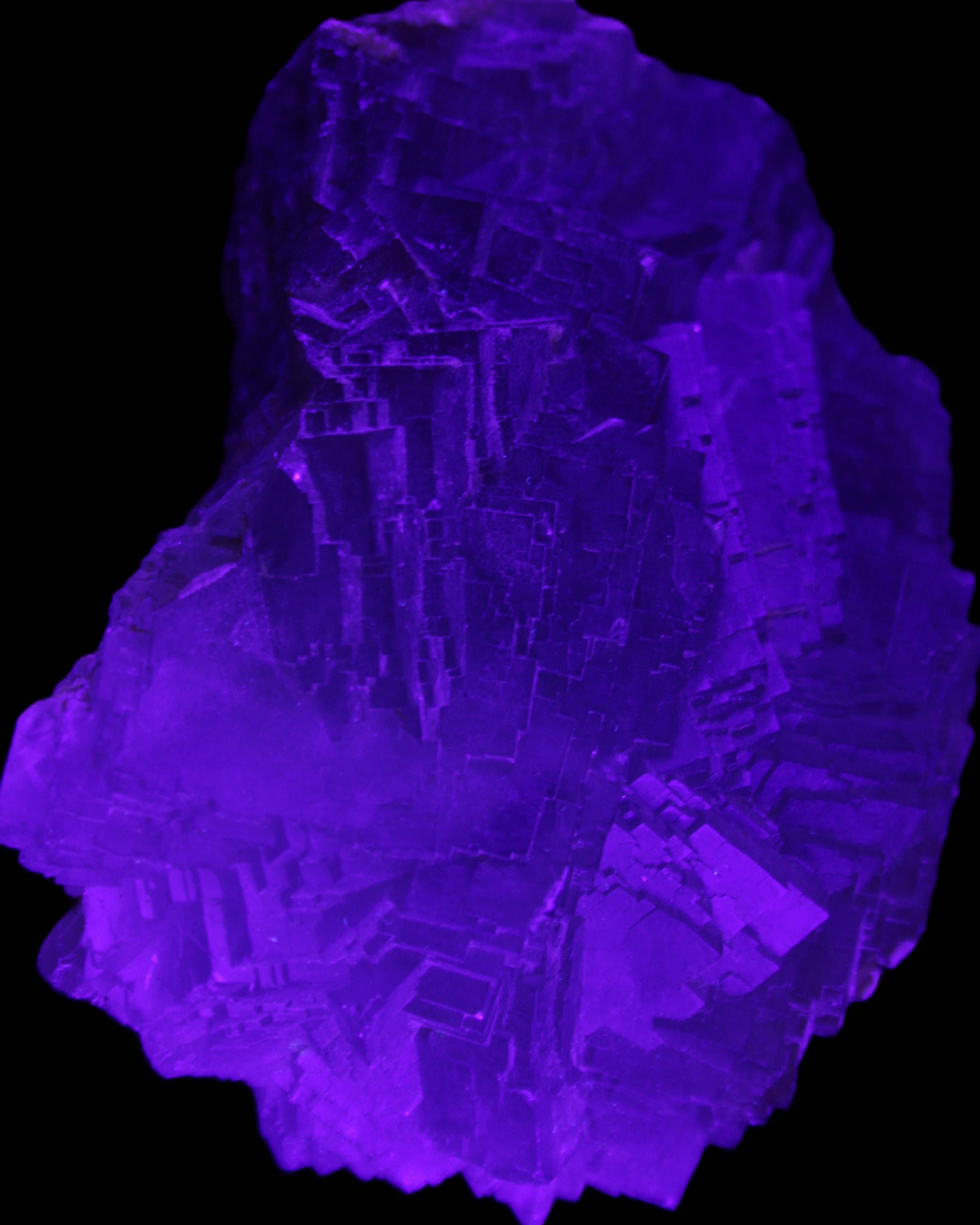 Clear Fluorite cubic stepped cluster 104*72*50mm 660g in UV light - Rocks and Things Store