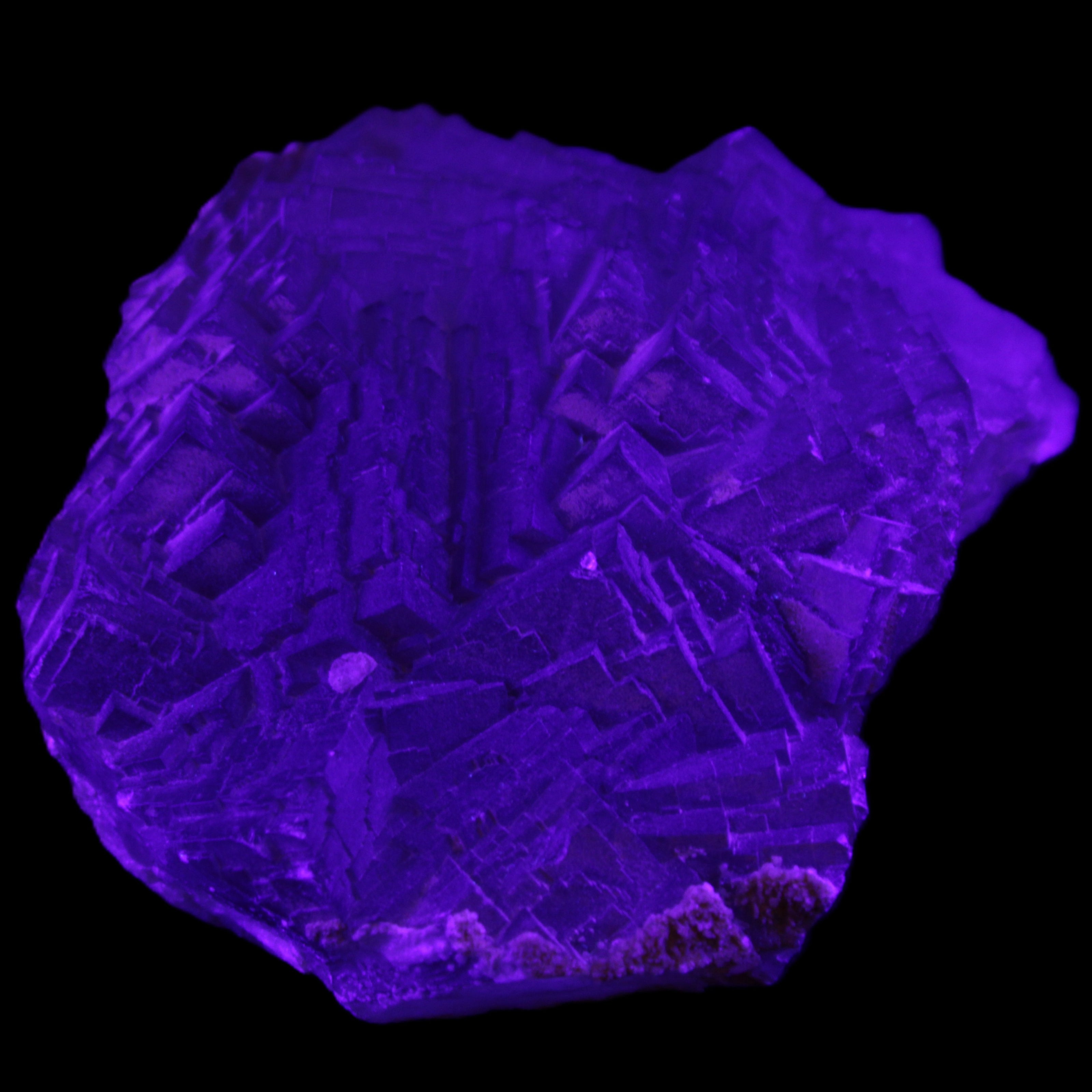 Clear Fluorite cubic stepped cluster 104*72*50mm 660g in UV light - Rocks and Things Store
