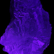Clear Fluorite cubic stepped cluster 104*72*50mm 660g in UV light - Rocks and Things Store