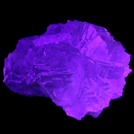 Clear Fluorite cubic stepped cluster 104*72*50mm 660g in UV light - Rocks and Things Store