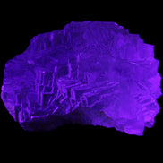 Clear Fluorite cubic stepped cluster 104*72*50mm 660g in UV light - Rocks and Things Store