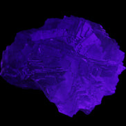 Clear Fluorite cubic stepped cluster 104*72*50mm 660g in UV light - Rocks and Things Store