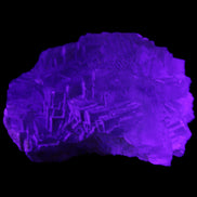 Clear Fluorite cubic stepped cluster 104*72*50mm 660g in UV light - Rocks and Things Store