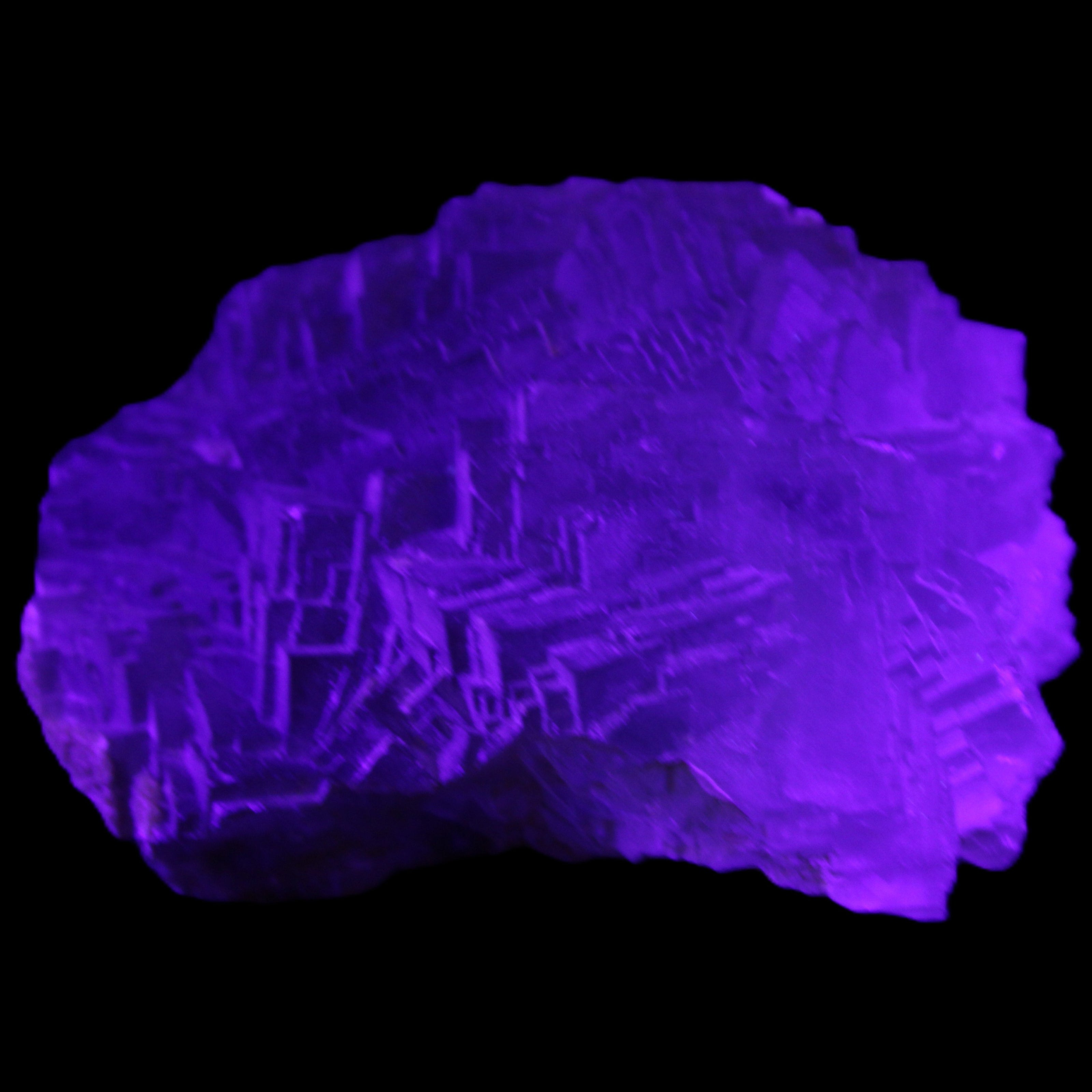 Clear Fluorite cubic stepped cluster 104*72*50mm 660g in UV light - Rocks and Things Store