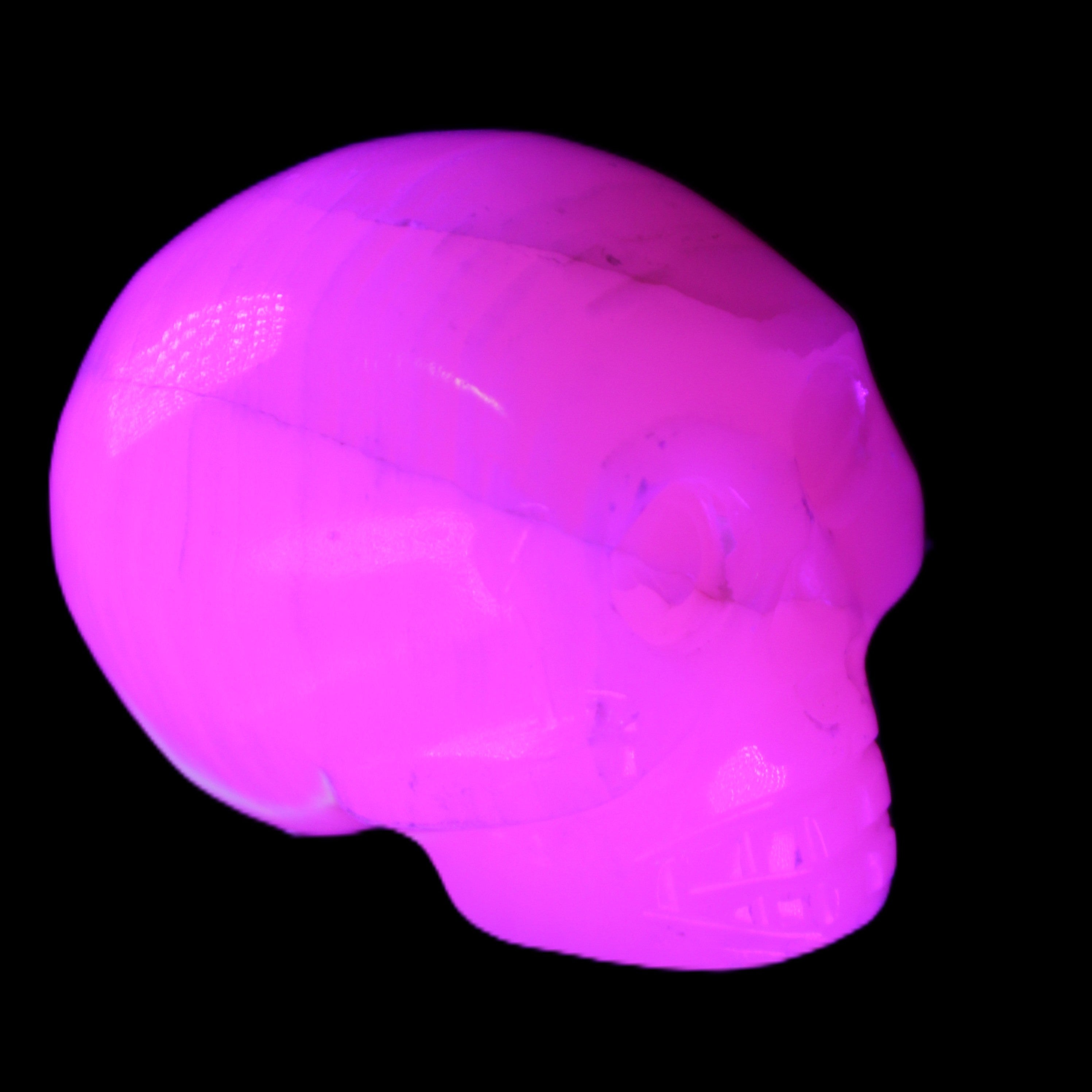 Mangano Calcite skull 31*47*40mm 87g in UV light - Rocks and Things Store