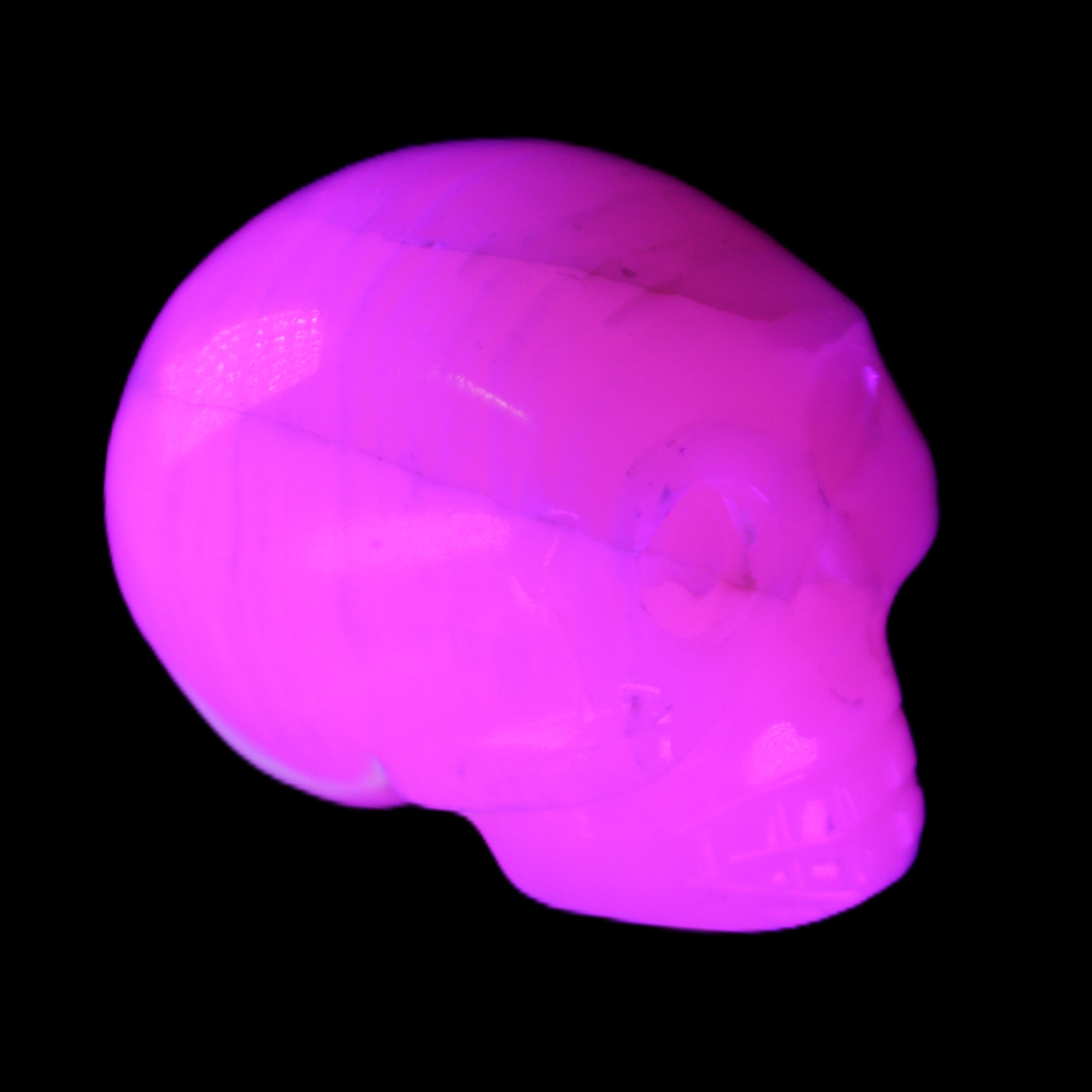 Mangano Calcite skull 31*47*40mm 87g in UV light - Rocks and Things Store